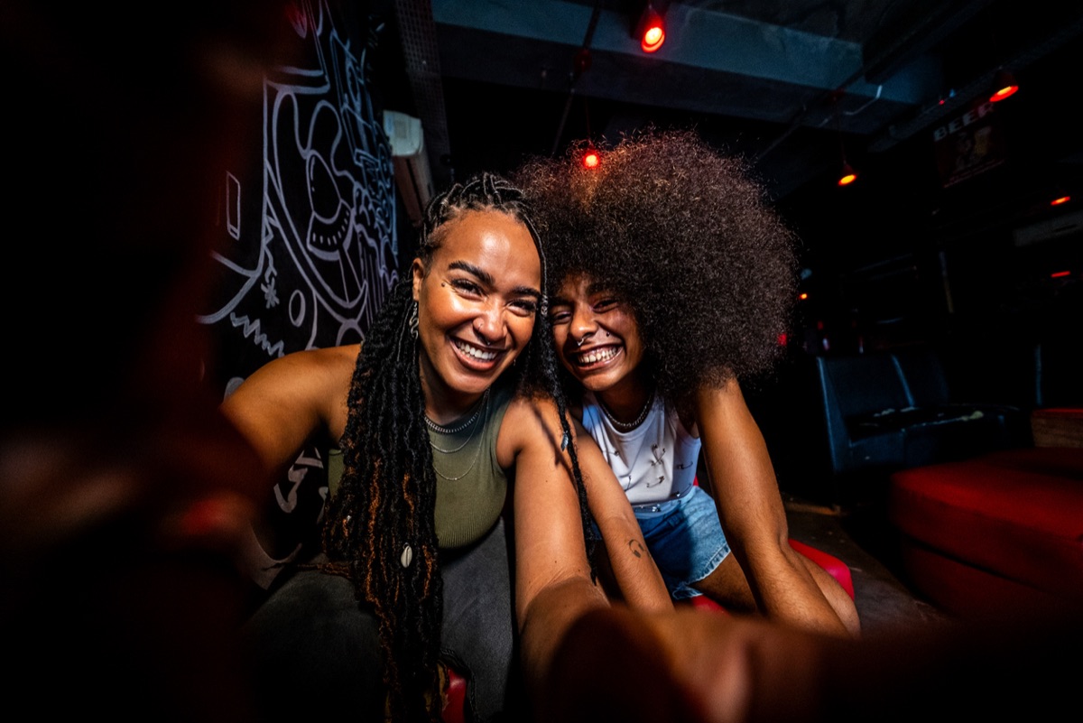 Two friends laughing into the camera during the photo stop of the crawl in San Salvador